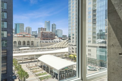 the view of a train station and the city from a window